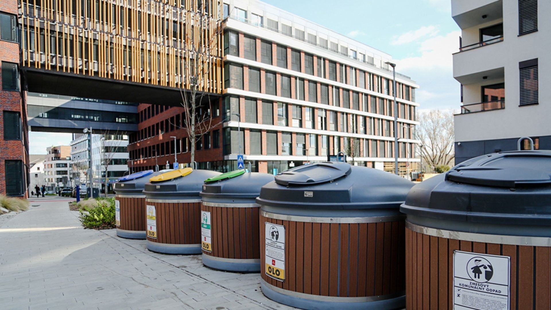 Public waste bins outside a modern municipal building